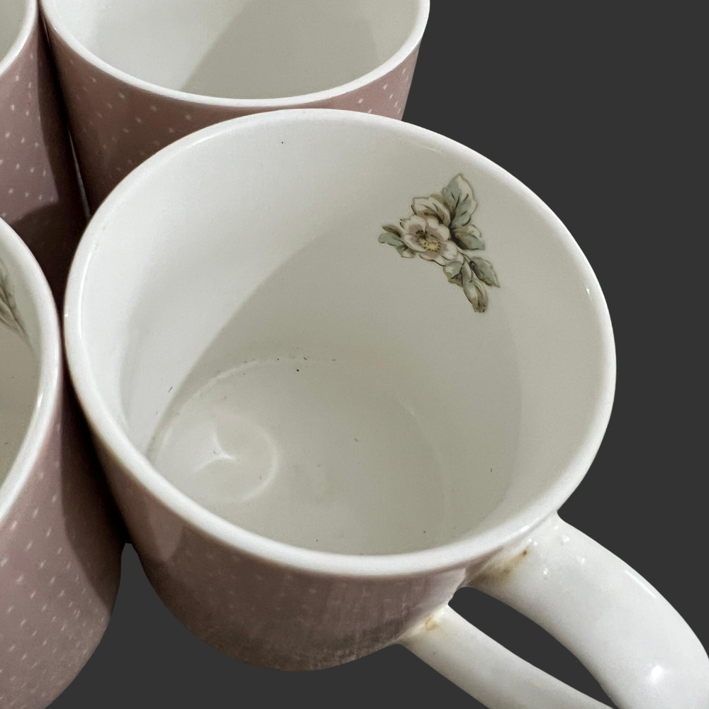 Close-up of a ceramic mug with floral design on a dark background