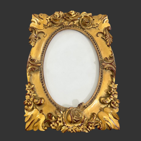 Decorative gold frame with intricate designs on a dark background