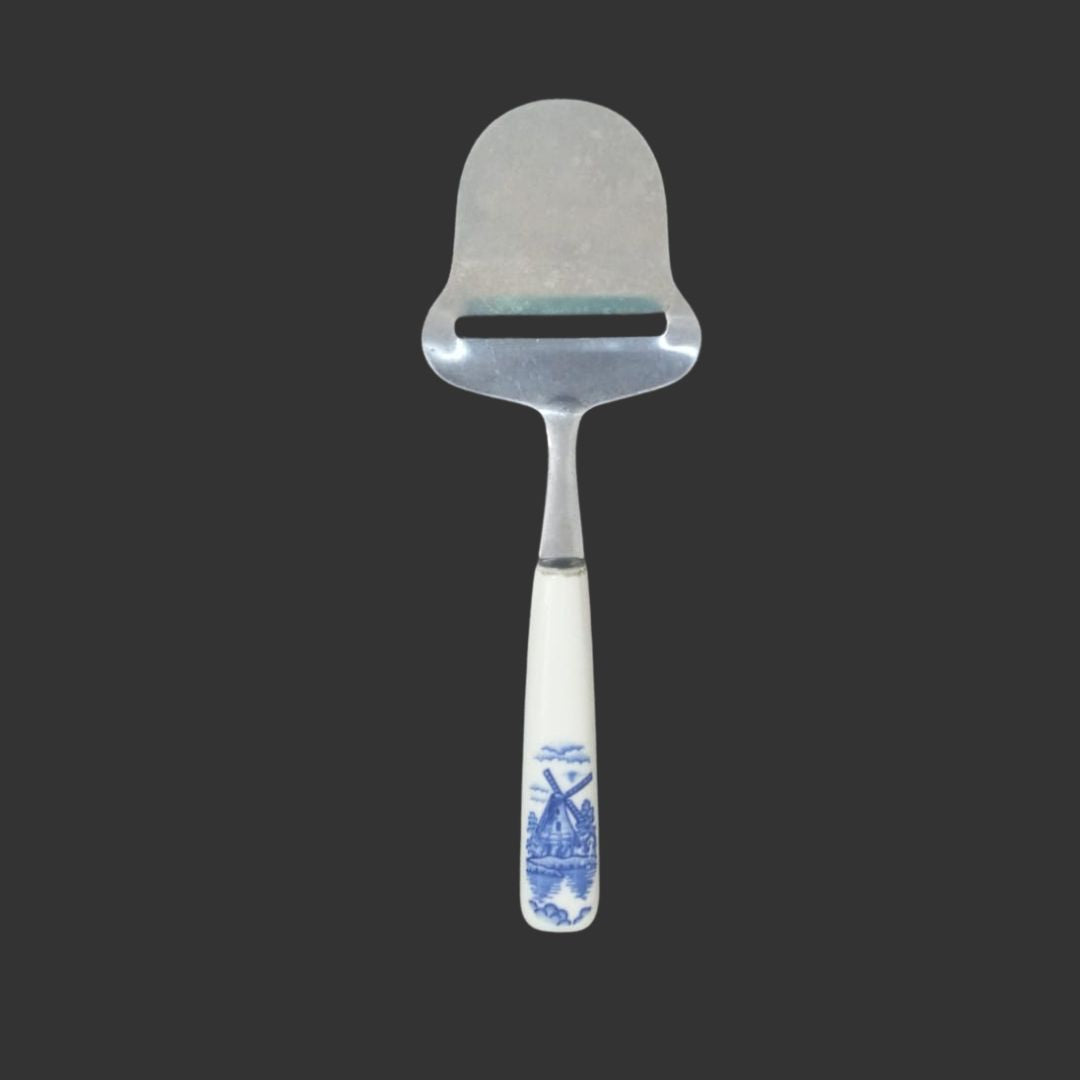 Metal spatula with a decorative handle on a black background