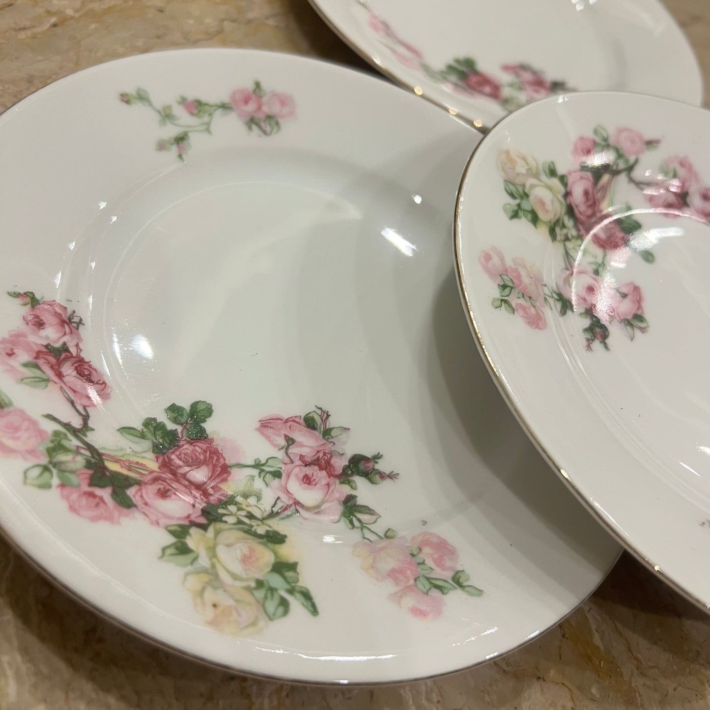 Set of floral-patterned plates on a marble surface