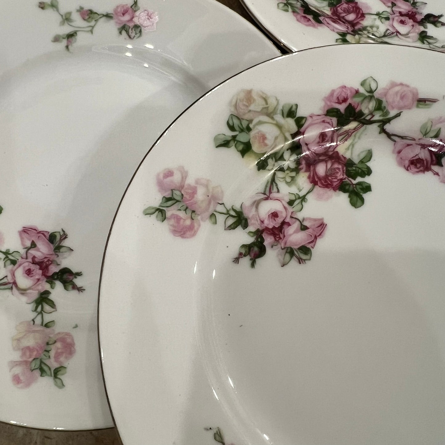 Set of ceramic plates with floral designs on a white background