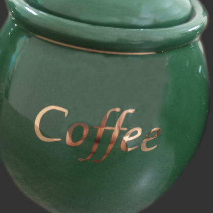 Green coffee jar with 'Coffee' inscription on a dark background