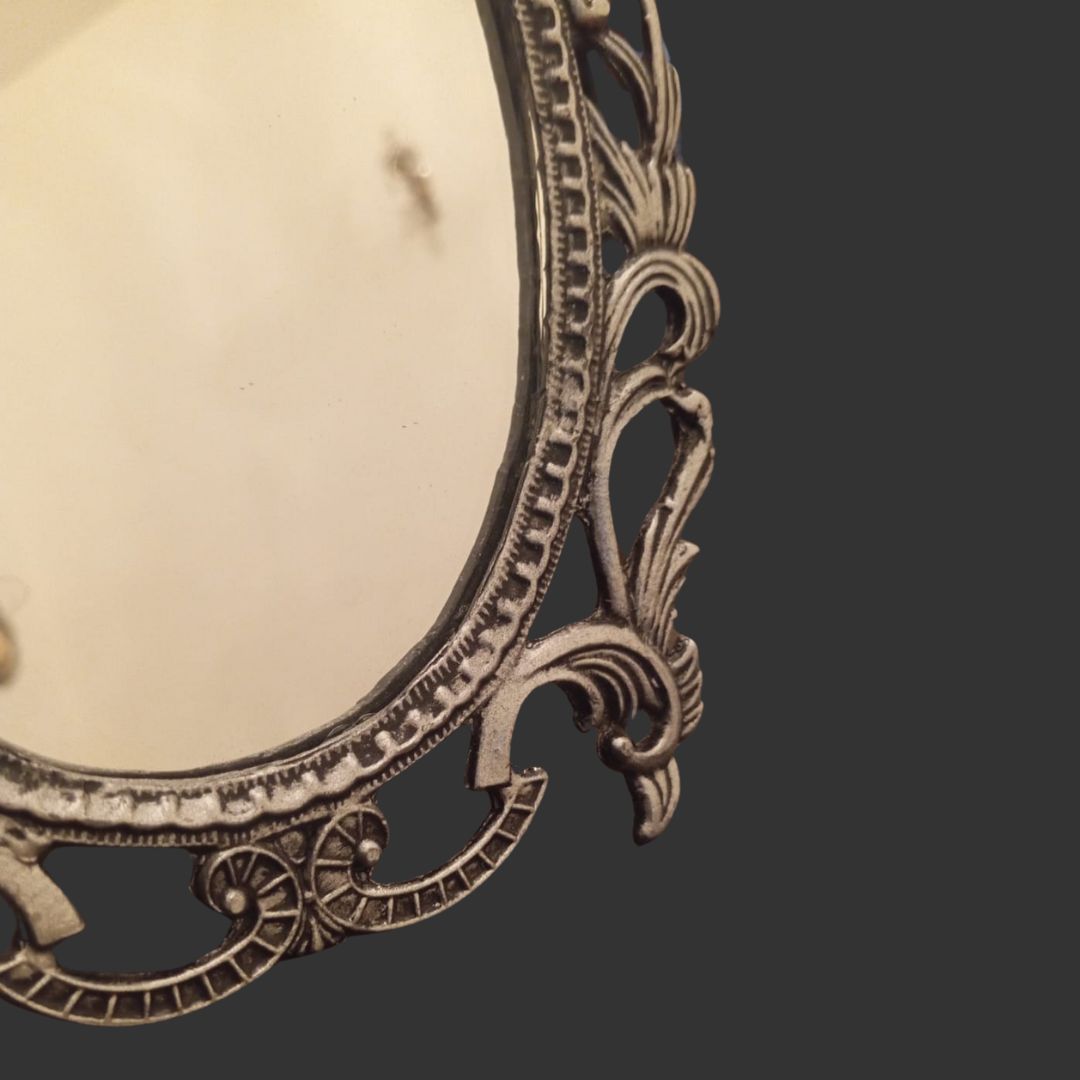 Decorative metal frame with intricate designs on a dark background
