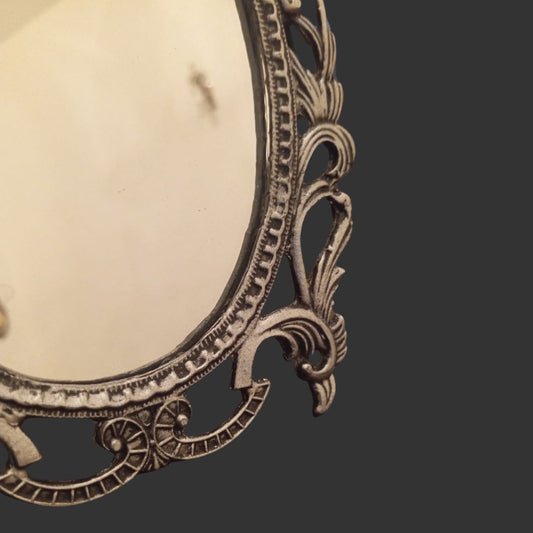 Decorative metal frame with intricate designs on a dark background