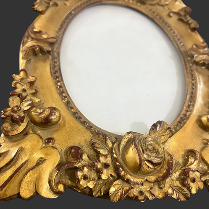 Decorative gold frame with intricate designs on a white background