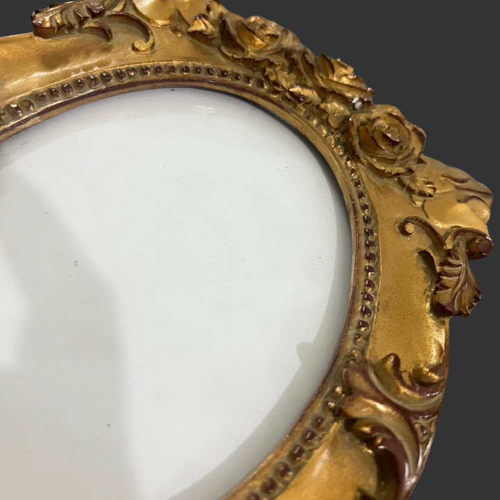 Close-up of a gold ornate frame with a white center